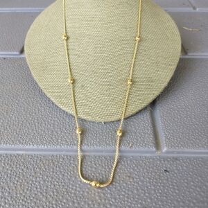 Women's gold tone bead chain necklace.